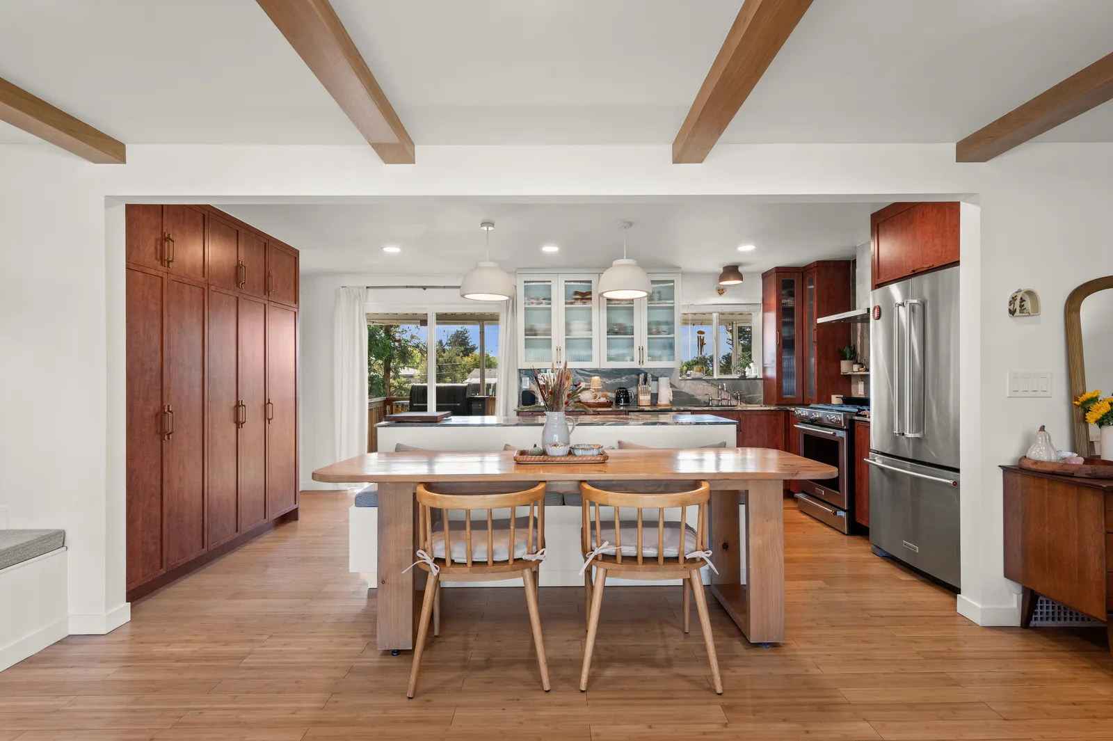 Open-concept living, dining, and kitchen with wood floors in a Holladay whole-home remodel